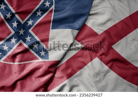 big waving colorful national flag of alabama state and flag of mississippi state . macro