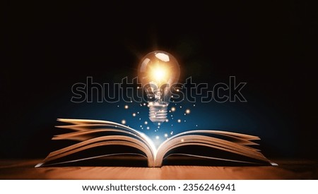 Glowing lightbulb over a book, Inspiring from read concept, Education knowledge and business education ideas, Innovations, self-learning, knowledge and searching for new ideas. Thinking for new idea. Royalty-Free Stock Photo #2356246941