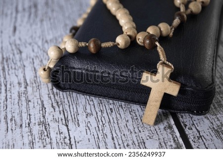 Christian wooden crucifix on open bible, point focus. Religious concept image, black and white image. Royalty-Free Stock Photo #2356249937