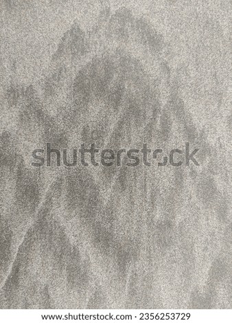 A picture of gray sands on beach captures a unique and tranquil coastal scene. The muted, neutral tones of the gray sands create a soothing and calm atmosphere.