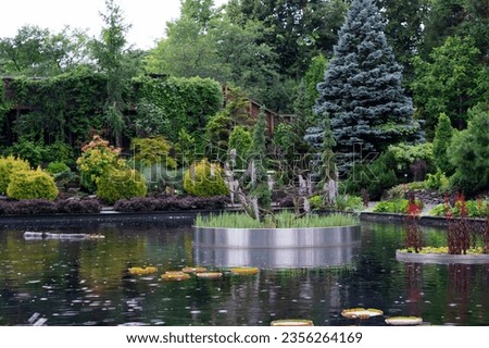 Pond in the green summer garden durin the rain. Montreal botanical garden location
