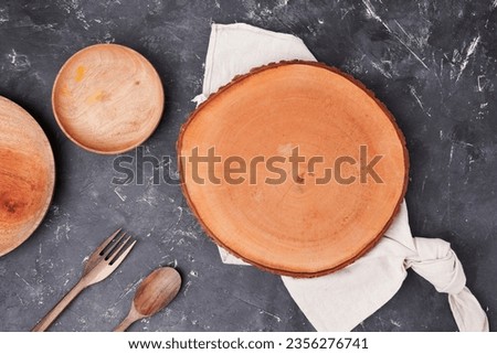 mockup of a round wooden tray on a black background. food photography background.