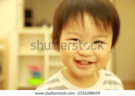 Image of a smiling boy playing
