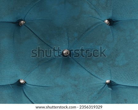 the background of a sofa that looks soft and soft in a close-up photo, the blue color looks dull and dirty