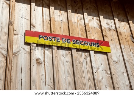 poste de secours french text means Lifeguard on wall facade wooden cabin hut on Beach