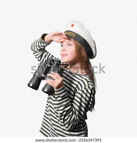 Portrait of a sailor girl on a white background teenage girl in a sailor suit with a binocular looking into the distance. Royalty-Free Stock Photo #2356347391