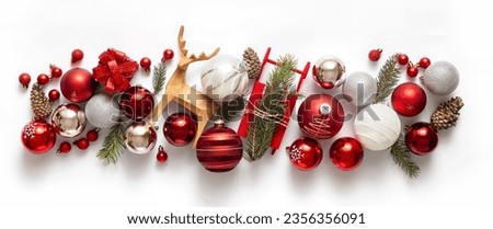 Colorful christmas composition with fir branches, gift box and various Christmas decorations on white background. Winter holidays, New Year concept 