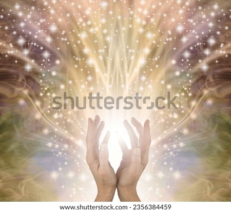 Golden Sparkling Magical Energy Healing Hands Sensing star light - ethereal gold coloured background with an outpouring of stars from cupped female hands reaching up and space for spiritual message
