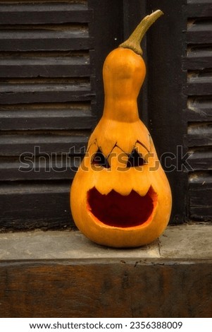 Pumpkin with a fear-evoking face for Halloween and All Saints' Eve atmosphere.
