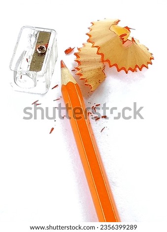 Orange wooden pencil sharpener placed on a white paper.
