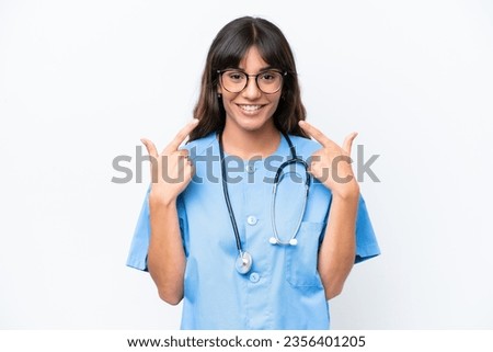 Young caucasian nurse woman isolated on white background giving a thumbs up gesture