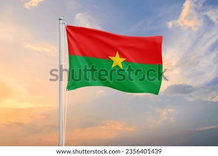 Burkina Faso flag waving on sundown sky