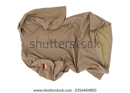 Crumpled Brown German Armed Forces T-Shirt On White Background With German Flag Patch, Bundeswehr T-Shirt, German Army T-Shirt, Shirt German Army, Military Shirt, Military T-Shirt, Camouflage Shirt Royalty-Free Stock Photo #2356404803