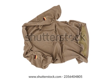 Crumpled Brown German Armed Forces T-Shirt On White Background With German Flag Patch, Bundeswehr T-Shirt, German Army T-Shirt, Shirt German Army, Military Shirt, Military T-Shirt, Camouflage Shirt Royalty-Free Stock Photo #2356404805