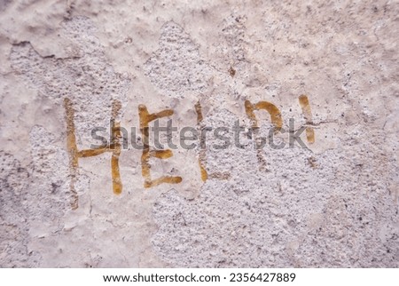 The inscription help on the concrete wall