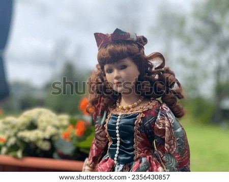 Beautiful ceramic dolls princess with background of front yard with grass and trees