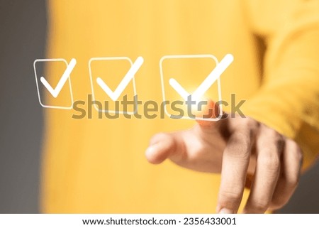 Checklist concept. Businessman touching Checking mark on checkboxes.