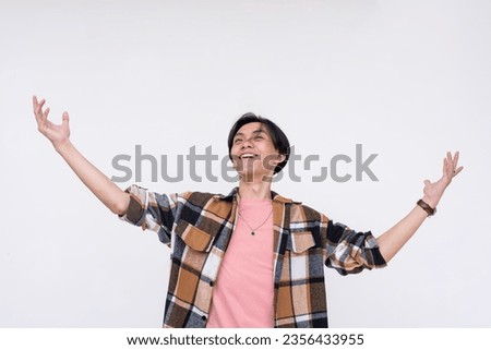 A overconfident and egotistical young man looking up and proclaiming himself to be the best in the world. Isolated on a white background. Royalty-Free Stock Photo #2356433955