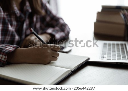 Asian woman student study online with skype teacher, happy young woman learn language listen lecture watch webinar look at laptop sit in home, distance education Royalty-Free Stock Photo #2356442297