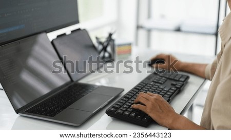 Developer programmer checking code on multiple monitor while programming to developing web and apps.