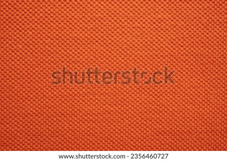 Full frame shot of orange polyester fabric texture and background. Royalty-Free Stock Photo #2356460727