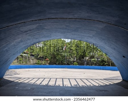 view of the red and white Indonesian flag flying from inside the Iconic tunnel at Wisdom Park, Gadjah Mada University, Yogyakarta, 3 September 2023 Royalty-Free Stock Photo #2356462477
