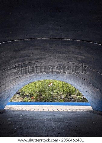 view of the red and white Indonesian flag flying from inside the Iconic tunnel at Wisdom Park, Gadjah Mada University, Yogyakarta, 3 September 2023 Royalty-Free Stock Photo #2356462481
