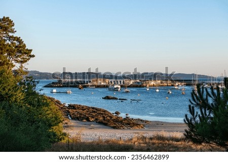 Wide-angle view of the beach and sport port of Portonovo in the Ria de Pontevedra at dusk, Spain.