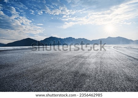Empty asphalt road and mountains nature scenery at sunrise Royalty-Free Stock Photo #2356462985