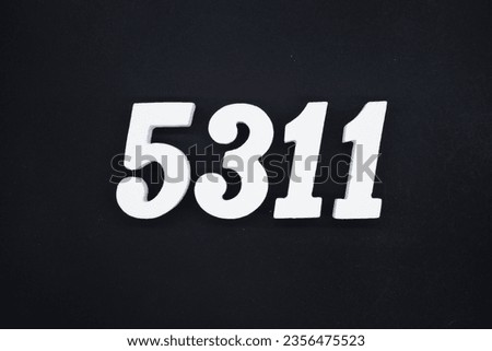Black for the background. The number 5311 is made of white painted wood.