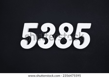 Black for the background. The number 5385 is made of white painted wood.