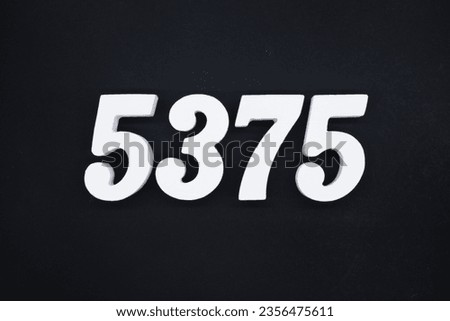 Black for the background. The number 5375 is made of white painted wood.