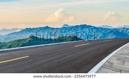 Asphalt highway road and mountain natural scenery at sunrise. panoramic view. Royalty-Free Stock Photo #2356475977
