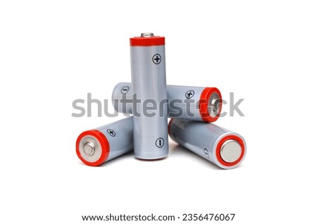 Stacking of AA alkaline batteries on white Royalty-Free Stock Photo #2356476067
