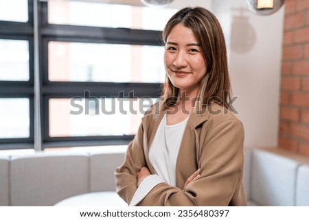 Smiling confident professional business woman corporate leader, happy mature female executive, lady manager standing in office and looking at camera.