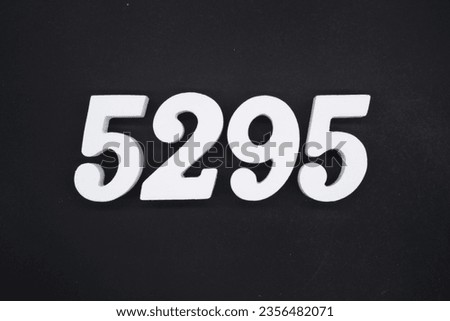 Black for the background. The number 5295 is made of white painted wood.