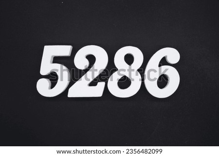 Black for the background. The number 5286 is made of white painted wood.