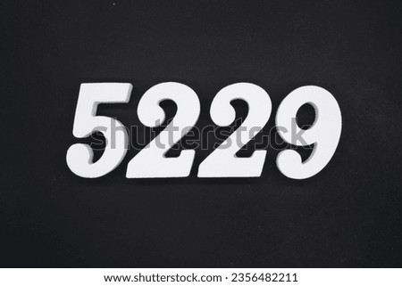 Black for the background. The number 5229 is made of white painted wood.