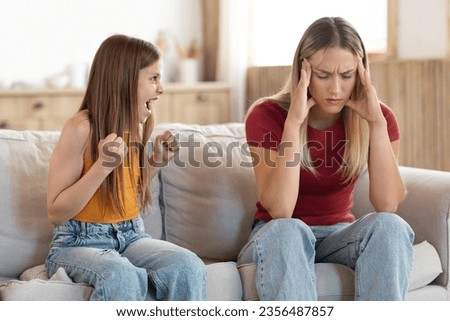 Stressed exhausted mother touch head feeling desperate about screaming stubborn teenager kid daughter tantrum, upset annoyed mom tired of naughty difficult child girl misbehave yelling for attention Royalty-Free Stock Photo #2356487857