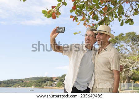 Vacation: Gay couple taking a selfie with mobile phone