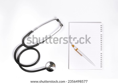 Top view doctor desk, shot from above of doctor table with notebook paper, pen, stethoscope flat lay display with copy space, top view photography project, medical doctor and healthcare concept.