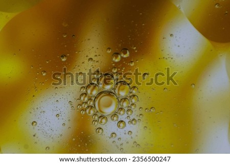 Abstract macro shot of oil droplets floating on water.