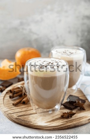 Seasonal autumn concept with hot drink. Pumpkin latte spice coffee on a stone background. Copy space.