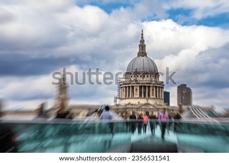 St Paul's Cathedral as seen across the Thames river from the Millennium Bridge. Commuters and tourist shown in motion blur.