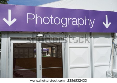 Photography here sign with arrows pointing to doors