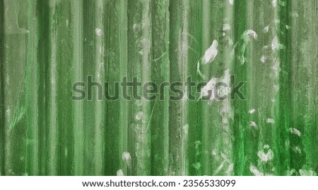 abstract old green galvanized corrugated metal sheet wall with rust used as background in close up view. grey rusty iron on metal construction site wall. Royalty-Free Stock Photo #2356533099