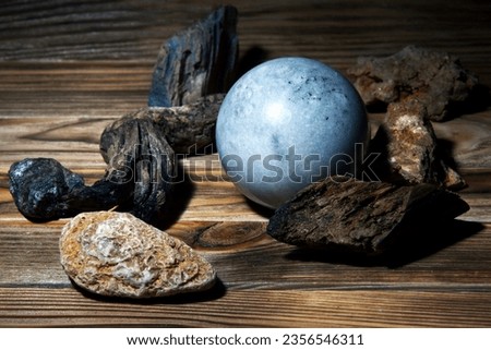 Blue sphere on a wooden background.