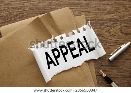 Appeal text on torn paper. wooden background Royalty-Free Stock Photo #2356550347