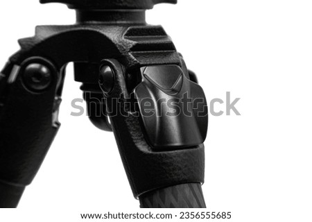 Modern carbon tripod. Lightweight portable stand for photo or video camera. Tripod for spyglasses and telescopes. Isolate on a white background. Royalty-Free Stock Photo #2356555685