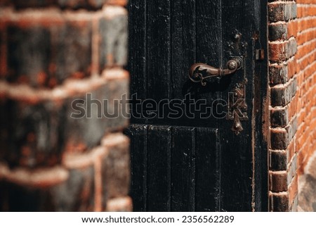 fragment of an old wooden door from the church entrance with an antique handle 